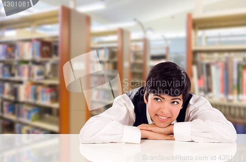 Image of Young Female Mixed Race Student Daydreaming In Library Looking T