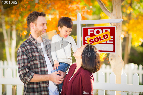 Image of Young Mixed Race Chinese and Caucasian Family In Front of Sold F