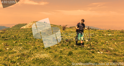 Image of Man Hiking in Green Mountains