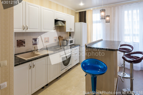 Image of Interior of a one-room apartment, view of a kitchen set and a bar counter