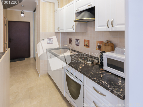 Image of Interior of a one-room apartment, view from the kitchen to the entrance door