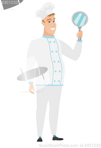 Image of Caucasian chef cook holding hand mirror.