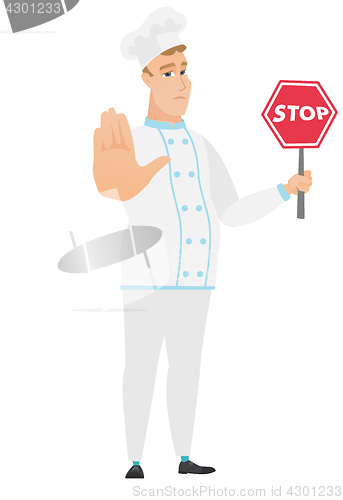 Image of Caucasian chef cook holding stop road sign.