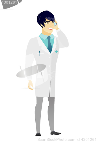 Image of Doctor talking on a mobile phone.