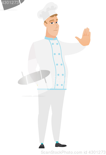 Image of Caucasian chef cook showing stop hand gesture.