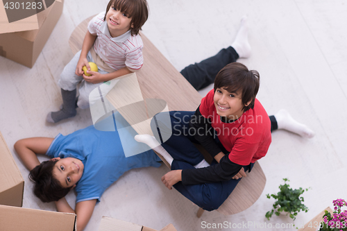 Image of boys with cardboard boxes around them top view