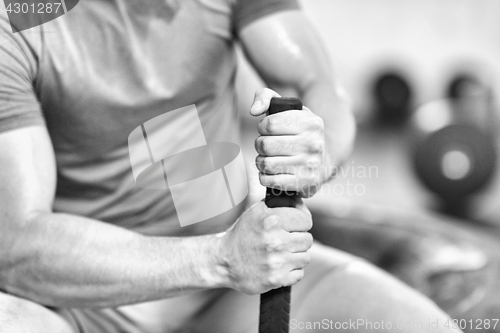 Image of young man after workout with hammer and tractor tire