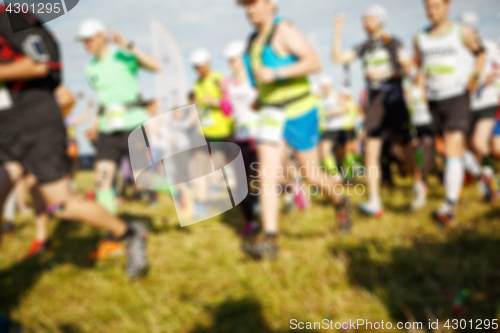 Image of Sportsmen running on green grass