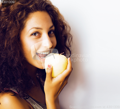 Image of pretty young real tenage girl eating apple close up smiling