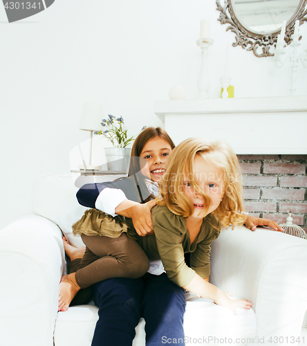 Image of two cute sisters at home playing, little girl in house interior 