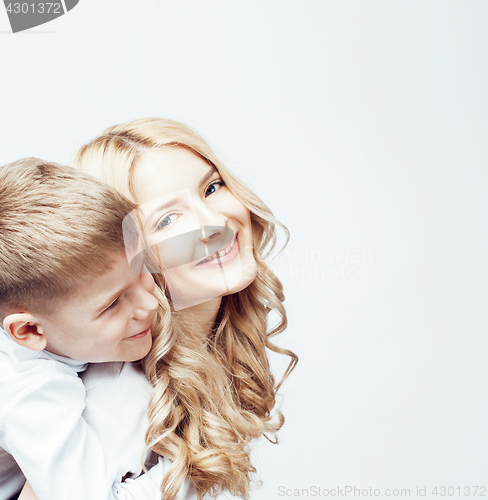 Image of young modern blond mother with cute son together happy smiling family posing cheerful on white background, lifestyle people concept, sister and brother friends