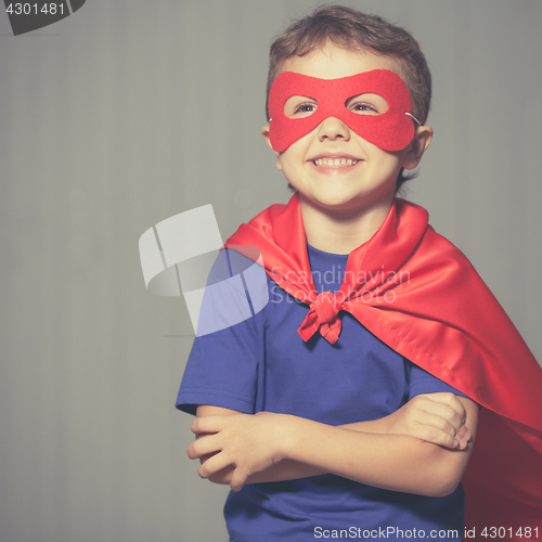 Image of Happy little child playing superhero.