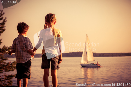 Image of Two happy children  playing in the park at the day time.