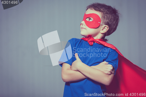 Image of Happy little child playing superhero.