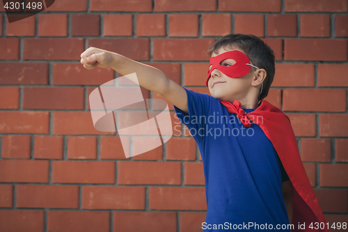 Image of Happy little child playing superhero.