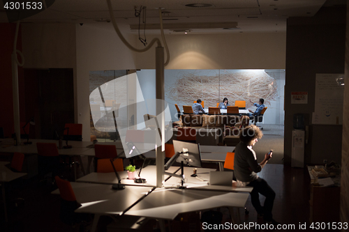 Image of man working on computer in dark office