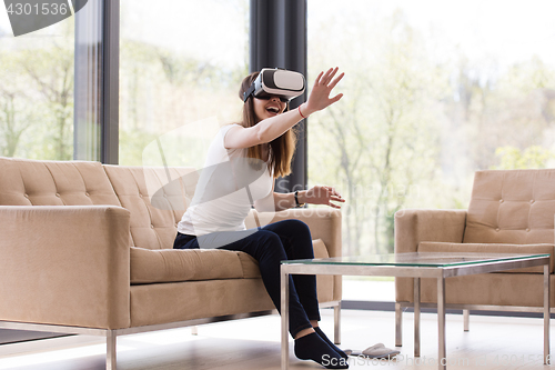 Image of woman using VR-headset glasses of virtual reality