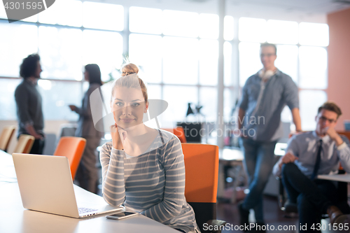 Image of businesswoman using a laptop in startup office