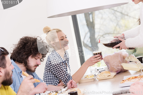 Image of multiethnic group of happy friends lunch time