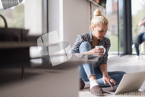 Image of young woman drinking coffee enjoying relaxing lifestyle