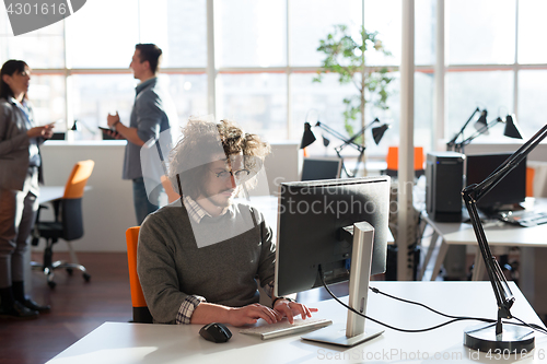 Image of businessman working using a computer in startup office