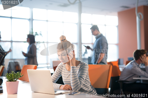 Image of businesswoman using a laptop in startup office