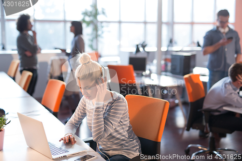 Image of businesswoman using a laptop in startup office
