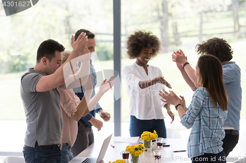 Image of multiethnic startup Group of young business people celebrating s