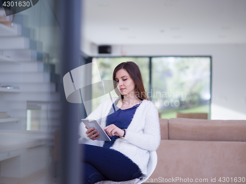 Image of young women using tablet computer by the window