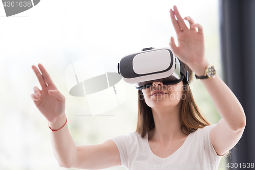 Image of woman using VR-headset glasses of virtual reality