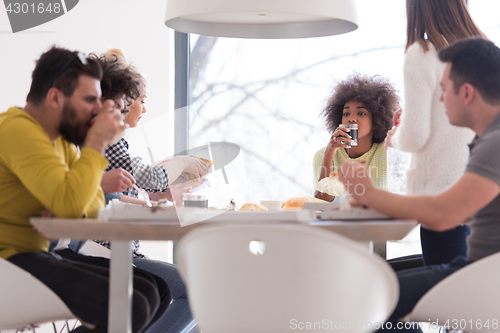 Image of multiethnic group of happy friends lunch time