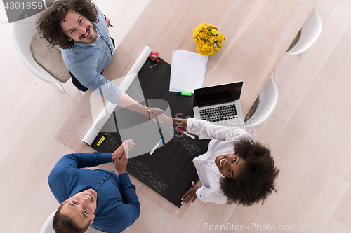 Image of top view of Multiethnic startup business team on meeting