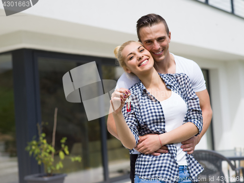 Image of couple hugging in front of  new luxury home