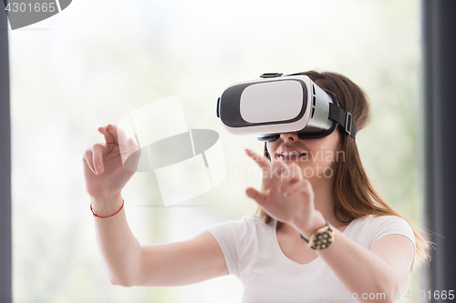 Image of woman using VR-headset glasses of virtual reality