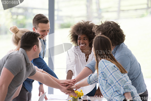 Image of multiethnic startup Group of young business people celebrating s