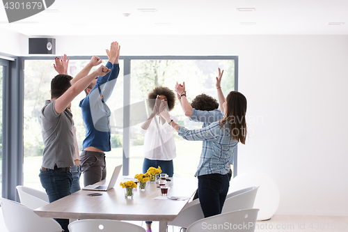 Image of multiethnic startup Group of young business people celebrating s