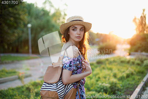 Image of Attractive young woman enjoying her time outside in park