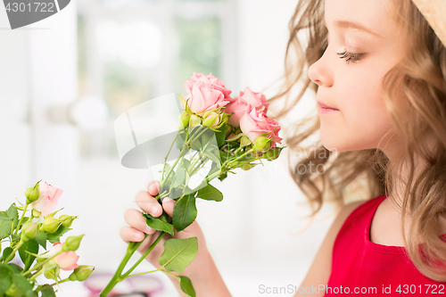Image of A little girl with roses