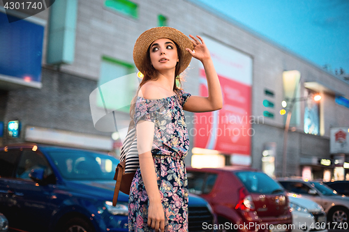 Image of The fashion woman portrait of young pretty trendy girl posing at the city in Europe