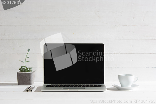 Image of The front view of notebook and cup of coffee. Inspiration and mock-up concept