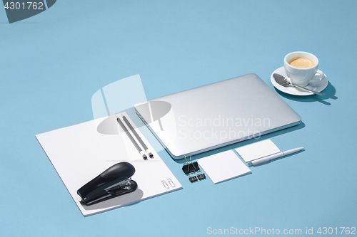 Image of The laptop, pens, phone, note with blank screen on table