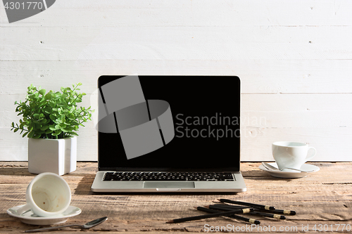 Image of The front view of notebook and cup of coffee. Inspiration and mock-up concept