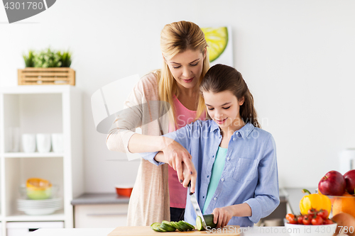 Image of happy family cooking dinner at home kitchen