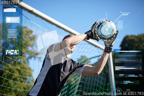 Image of goalkeeper with ball at football goal on field