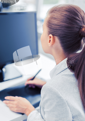 Image of businesswoman with drawing tablet in office