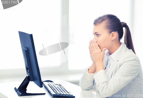 Image of stressed student with computer in office