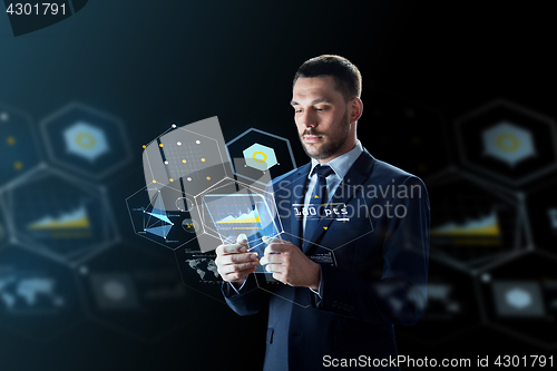 Image of businessman with tablet pc and virtual projections