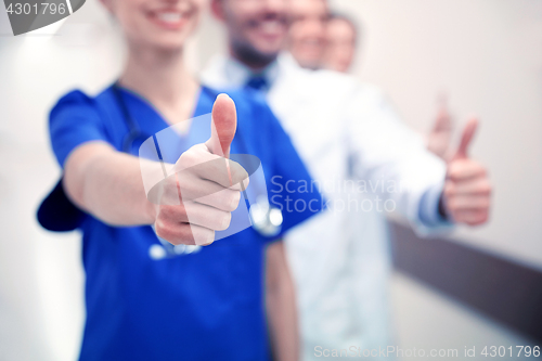 Image of close up of doctors at hospital showing thumbs