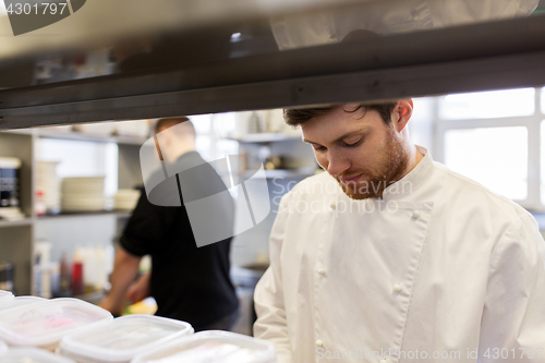 Image of chef and cook cooking food at restaurant kitchen