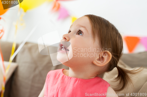 Image of happy baby girl on birthday party at home